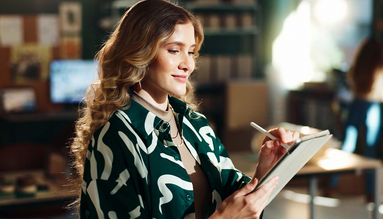 Woman using tablet for article on choosing a web design company in Ireland in 2026